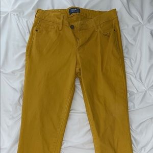 LIGHTLY WORN old nave rockstar mid-rise jeans in mustard yellow. no damage.